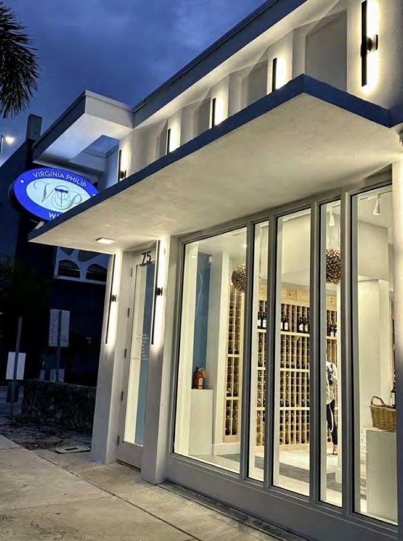 75 SE 4th Avenue storefront at dusk, white facade with downtown Delray signage